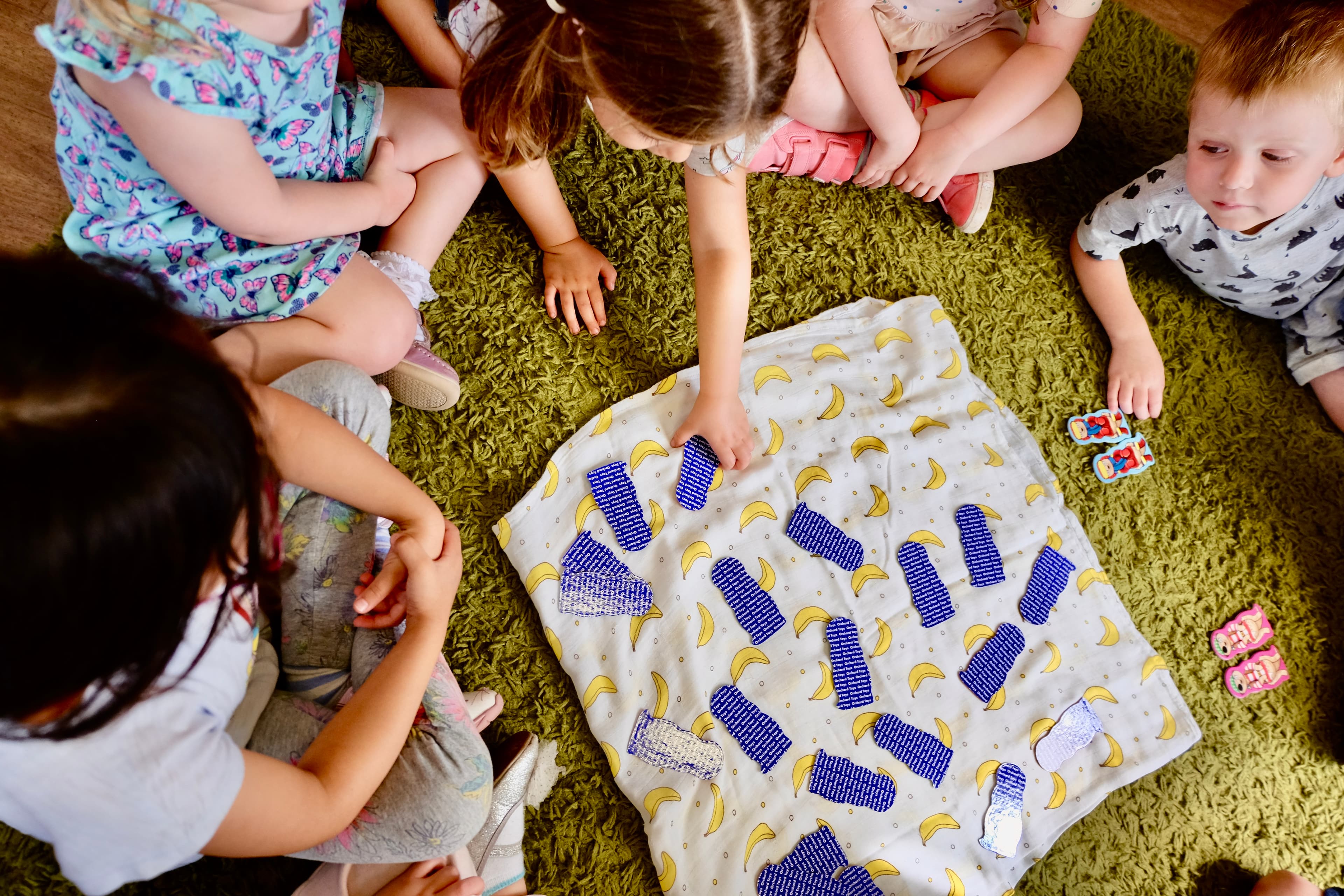 Children engaged in learning activities in the toddler room